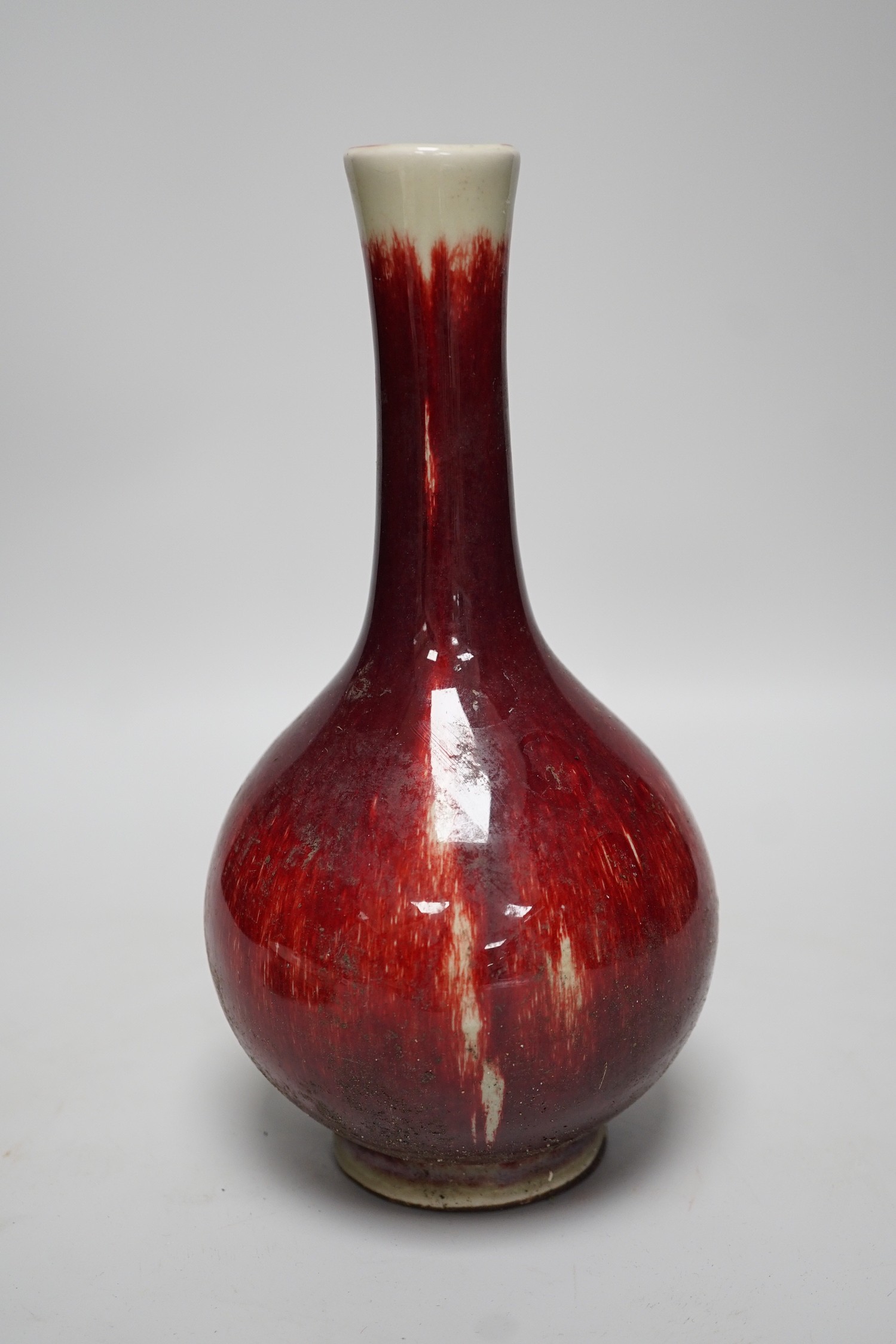 A Chinese sang de boeuf glazed bottle neck vase, together with a Chinese blue and white tea bowl, and a Chinese dish, tallest 23cm